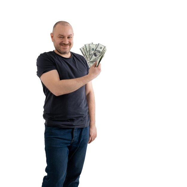 Volwassen casual man in spijkerbroek en een T-shirt met geld dollars in de hand geïsoleerd op witte achtergrond Winst rijkdom winnen van de loterij concept