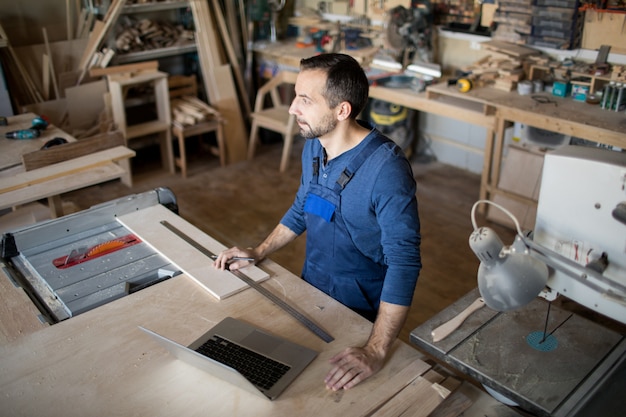 Volwassen timmerman in kleine winkel