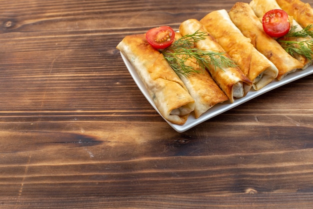 vooraanzicht gebakken groenten gebak met groenten en tomaten in plaat op bruine achtergrond koken voedsel bakken keuken brood gebak vlees