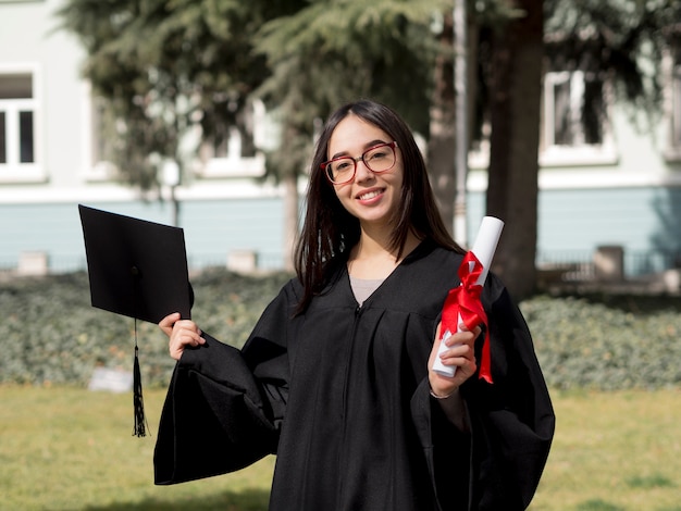 Vooraanzicht jonge vrouw die graduatietoga draagt