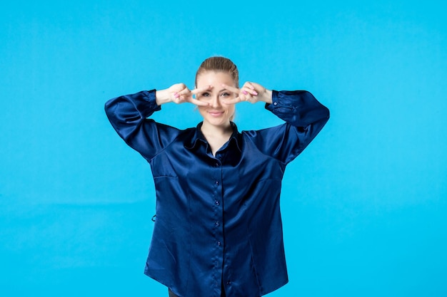 vooraanzicht jonge vrouw in pyjama op blauwe achtergrond nacht kleur slaap bed nachtmerrie glimlach feest droom moe rust vrouw geeuw