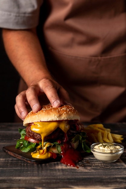 Foto vooraanzicht man hand zetten hamburger