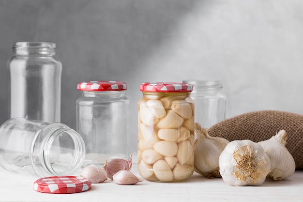 Foto vooraanzicht van gepekelde knoflook in helderglazen pot