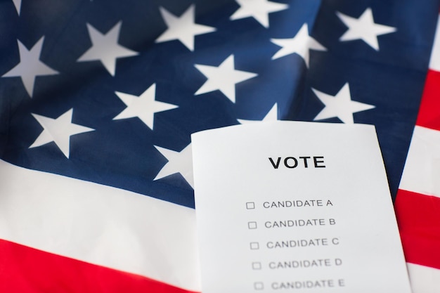 Photo voting, election and civil rights concept - empty ballot or vote on american flag