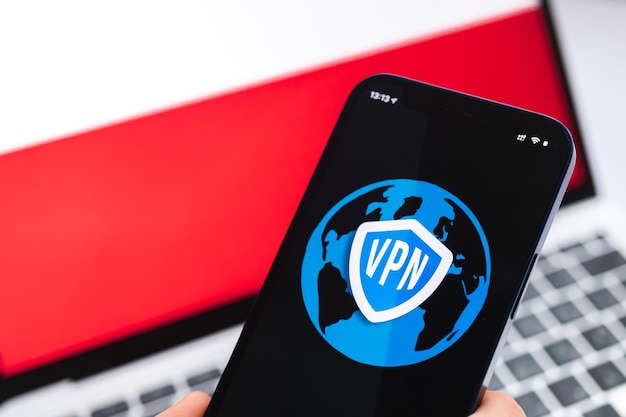 VPN in Polen Veilig en veilig internetconcept Privacy Hand met mobiele telefoon en VPN-applicatie Vlag en laptop op de achtergrondfoto