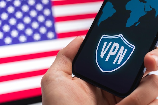 미국의 VPN 안전하고 안전한 인터넷 개념 USA Privacy Hand with mobile phone and VPN application in America Flag 및 노트북 배경 사진