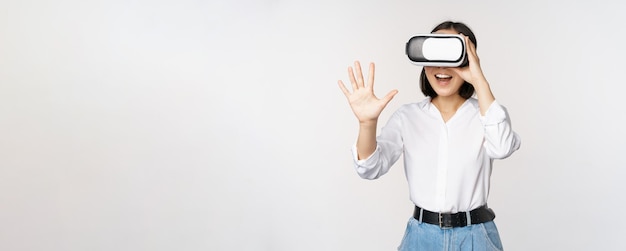 Vr chat Asian girl saying hello in virtual reality glasses smiling enthusiastic concept of communication and future technology white background