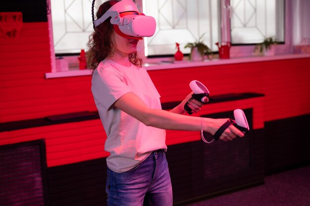 Photo vr game and virtual reality woman gamer fun playing on futuristic simulation video shooting game