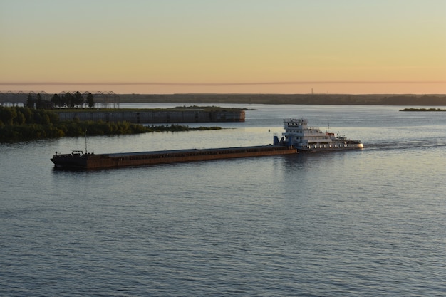 Vrachtschip vaart bij zonsopgang op de Wolga