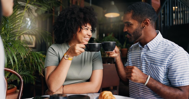 Vrienden cheers en koffie in het restaurant met praten binden samen en ontspannen op pauze op vakantie jonge man vrouw en communicatie door thee geluk en zorg voor cappuccino op vakantie in het café
