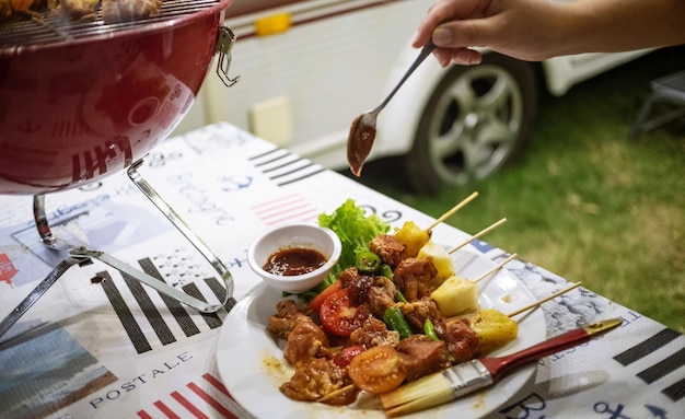 Vrienden die barbecue maken BBQ grillen boven een heet vuur in de natuurDiner feest