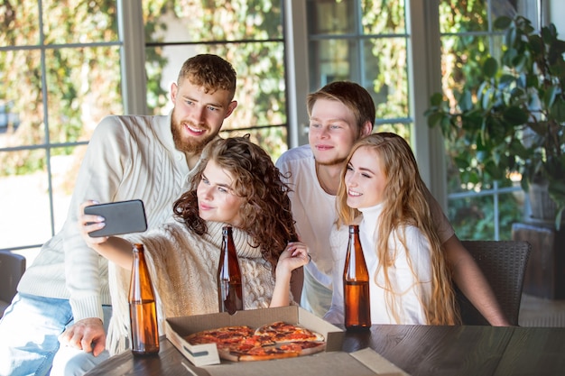 vrienden drie twee mannen en twee vrouwen jonge volwassenen mooi en gelukkig samen met mobiel