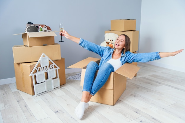 Vrij mooi meisje stak haar handen omhoog terwijl ze naar het nieuwe huis verhuisde.