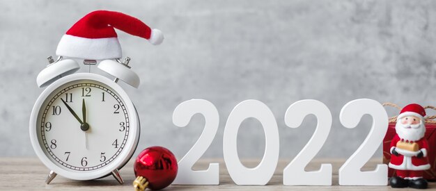 Vrolijk kerstfeest met vintage wekker en 2022 nummer op houten tafel. gelukkig nieuwjaar, feest, vakantie en tweede kerstdag concept