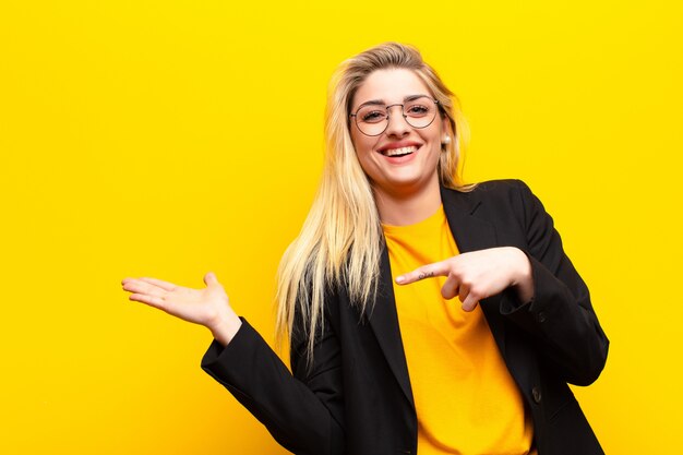 vrolijk lachend en wijzend om de ruimte op de palm aan de zijkant te kopiëren, een object te tonen of te adverteren