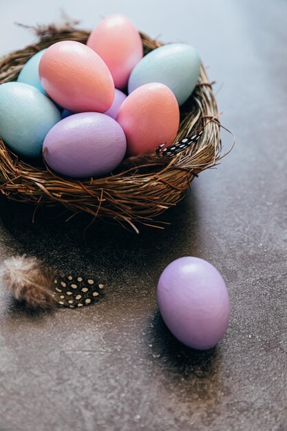 Vrolijk Pasen concept voorbereiding voor vakantie kleurrijke pastel versierde paaseieren in nest op grunge