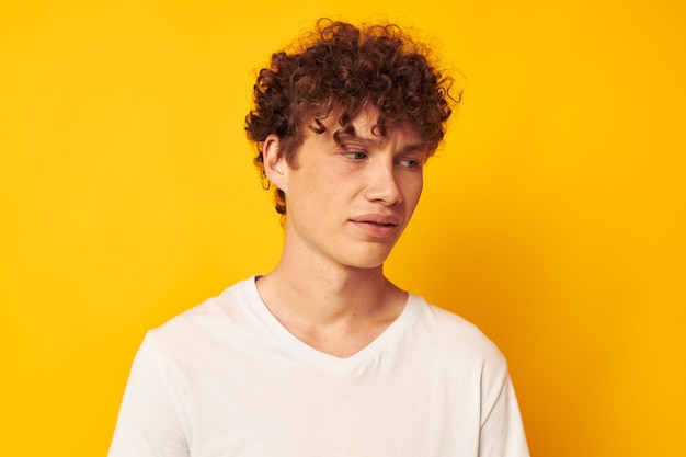 Vrolijke man met krullend haar in een witte t-shirt jeugdstijl