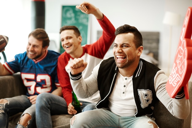 Vrolijke mannen die hun sportteam steunen