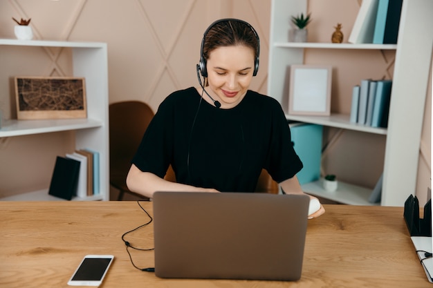 Vrolijke vrouw die aan laptop werkt