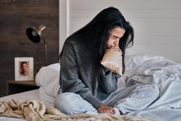 Vrouw angst en papieren zak stress ademhaling op bed in huis of thuis slaapkamer in echtscheidingscrisis huwelijk mislukken of weduwe verdriet Geestelijke gezondheid paniekaanval en depressie verlies persoon in controle adem