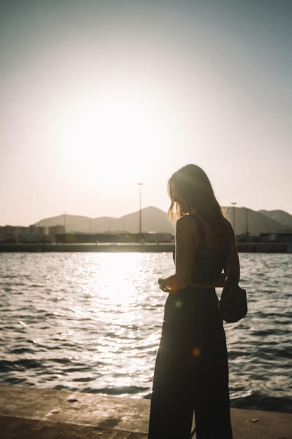 Vrouw bij de rivier tegen de lucht