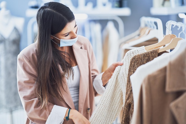 Vrouw bij het winkelen die masker draagt tijdens pandemie. Hoge kwaliteit foto