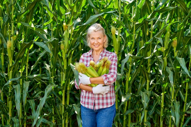 Vrouw boer met een oogst van maïs.