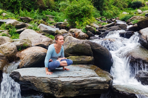 Vrouw die asana Tolasana van het wapensaldo doet