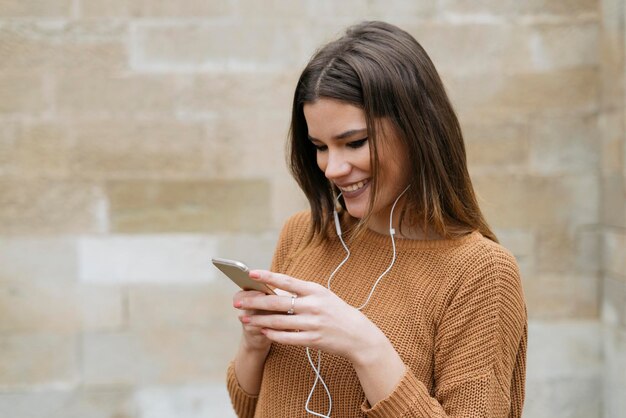 Vrouw die buitenshuis alleen mobiele telefoon gebruikt