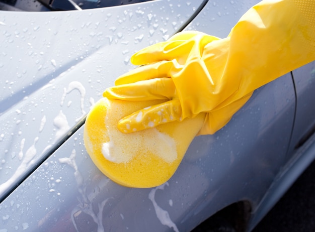 Vrouw die een auto schoonmaakt