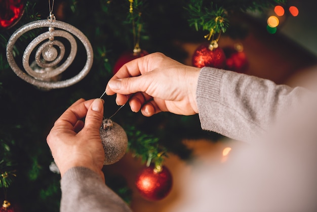 Vrouw die een Kerstboom verfraait