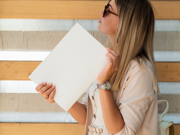 Vrouw die een modeltijdschrift houdt