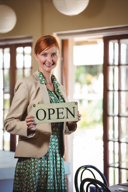 Vrouw die een teken met open houdt