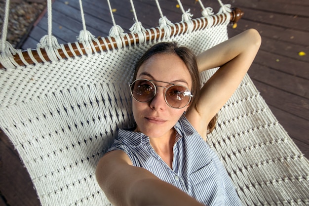 Vrouw die in hangmat pov legt vakantie selfie