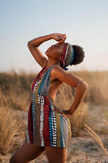 Vrouw die inheemse Afrikaanse kleding draagt in een dorre omgeving