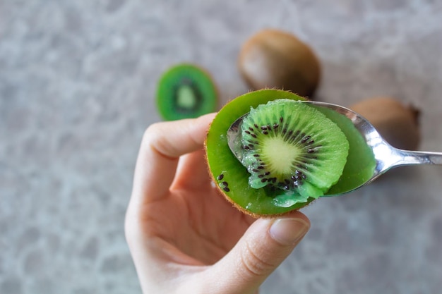 Vrouw die kiwi's eet. Gezond levensstijlconcept.