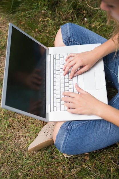 Vrouw die laptop in park met behulp van