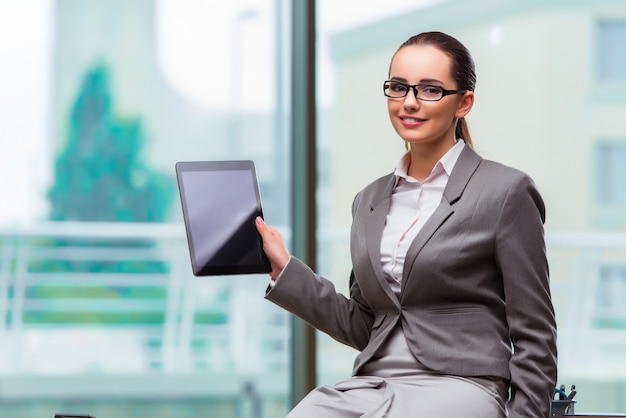 Vrouw die met tablet in bureau werkt