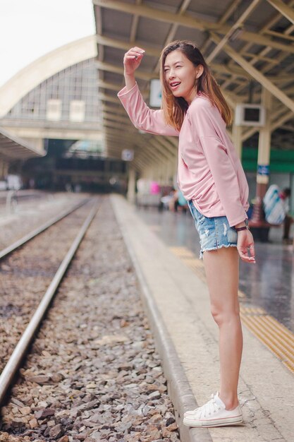 Foto vrouw die op het perron van het treinstation staat