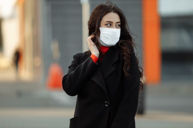 Vrouw die op straat loopt die beschermend masker draagt