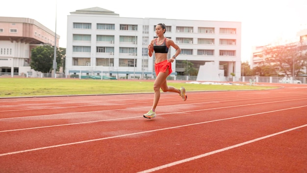 Vrouw die tijdens zonnige ochtend op stadionspoor loopt