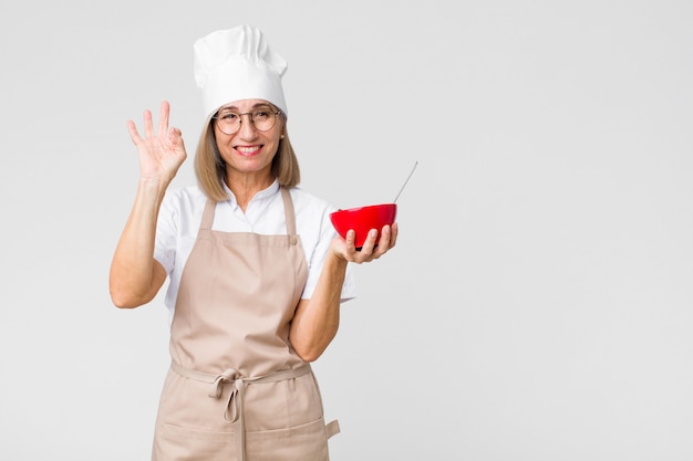 Vrouw die van de middelbare leeftijd de mooie bakker een ontbijtkom houdt