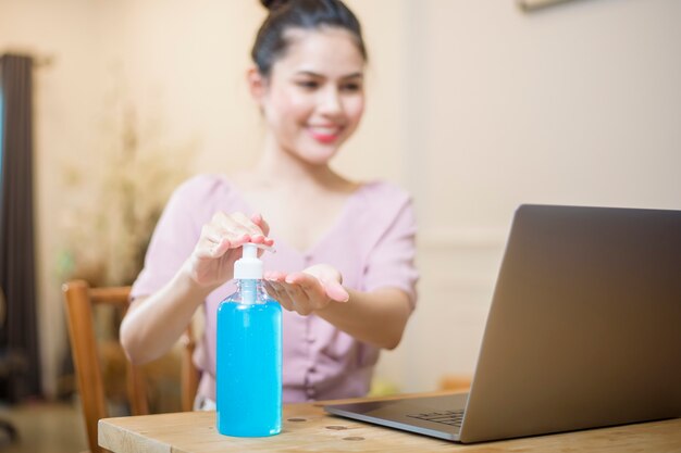 Vrouw die van huis met Alcoholgel werkt