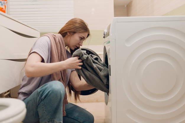 Vrouw die waskleren voorbereidt. De handen van de wasmachine houden een doek vast