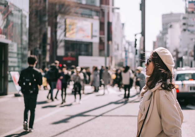 Vrouw die wegkijkt terwijl ze op straat staat