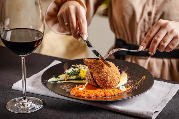 Vrouw eet een gehaktbal in een restaurant