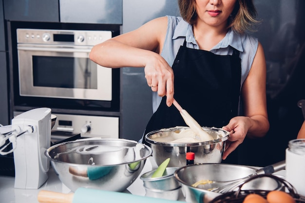 Vrouw eigenaar bakkerij vorm cake meel na beslag