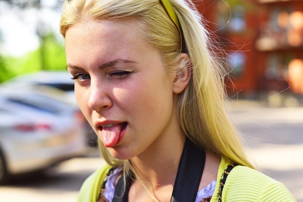 Foto vrouw emoties gezicht. meisje toont tong buiten.