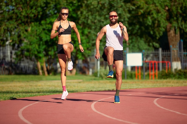 Vrouw en man joggen in het stadion