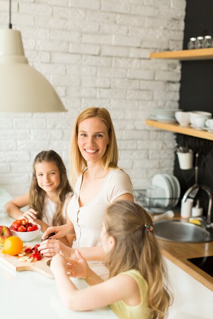 Vrouw en twee meisjes in de keuken